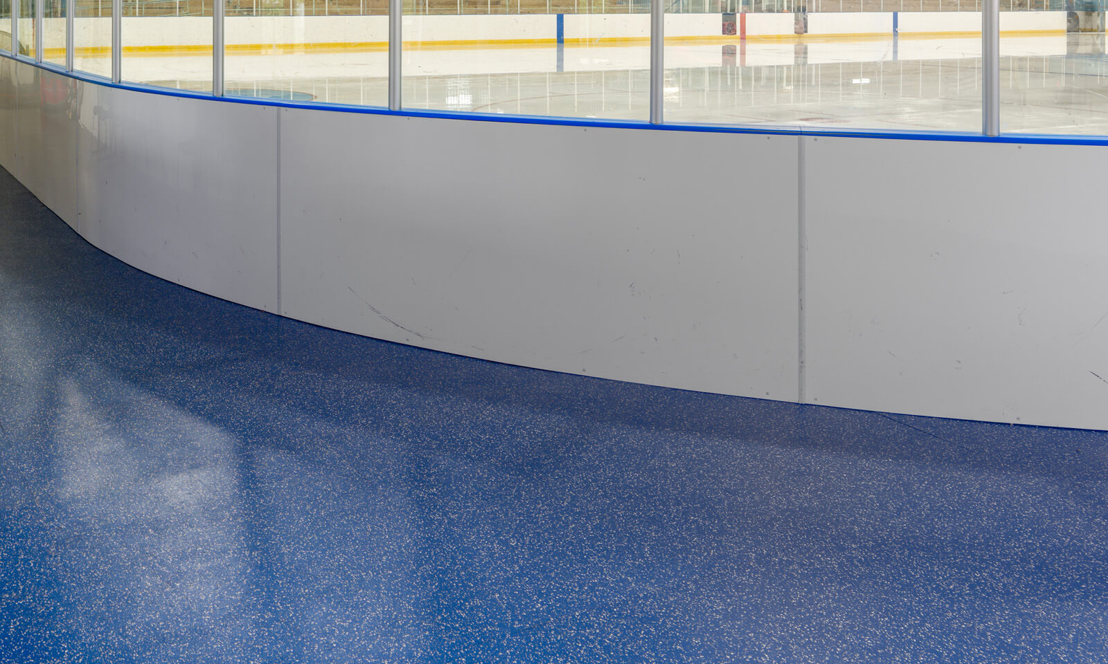 Blue sport flooring around an ice arena