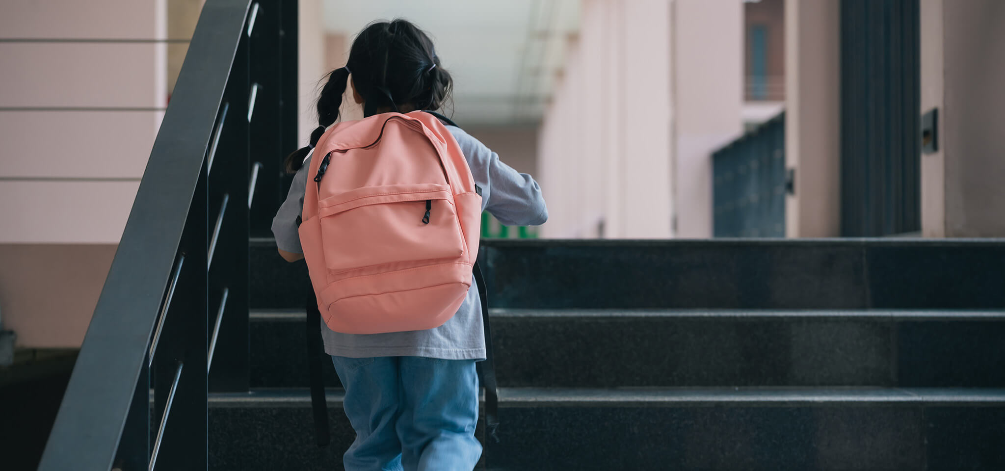Child walking up commercial stairs